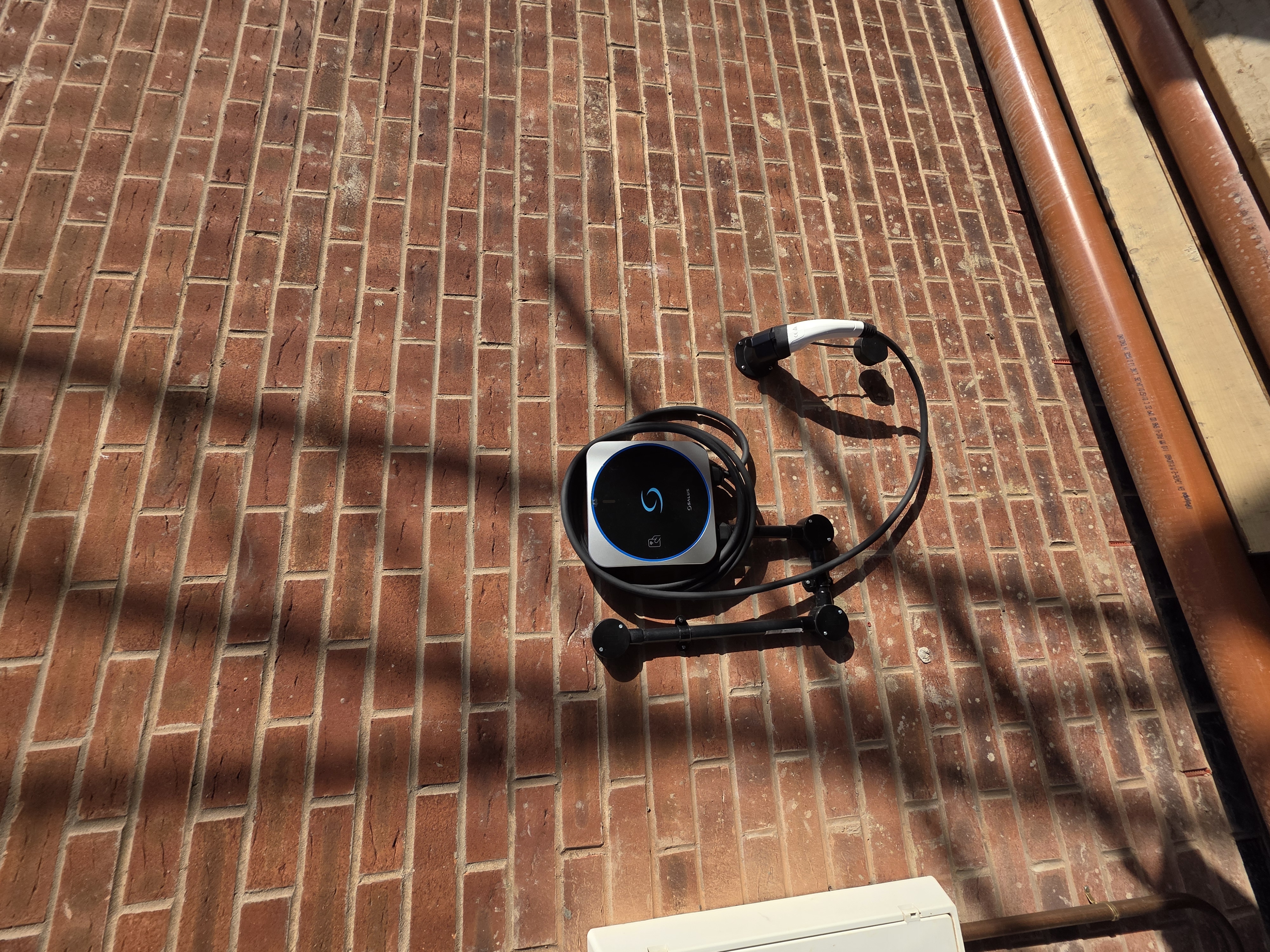 Salus home EV charger installed on a brick wall by CALLFIX