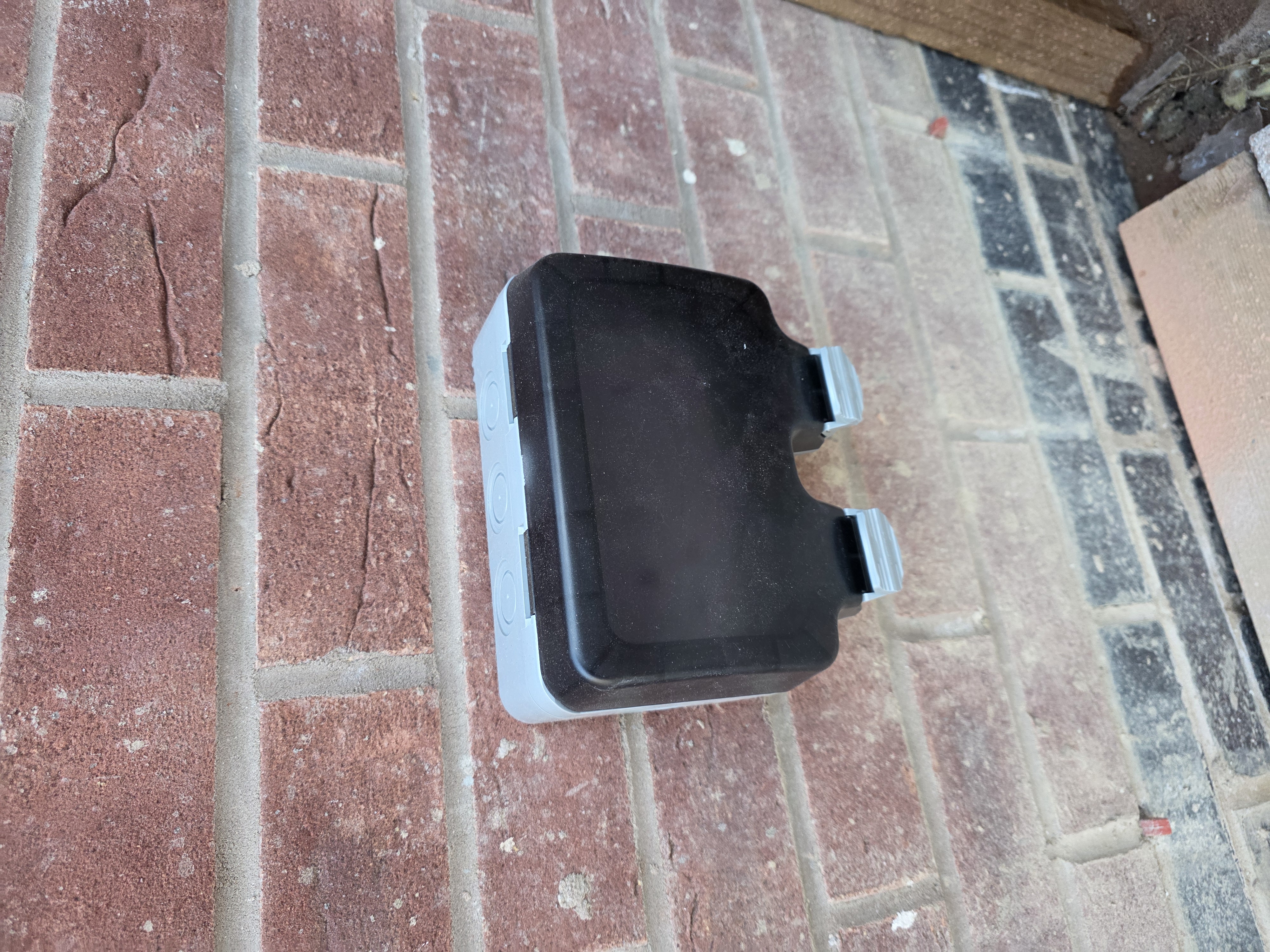 Weatherproof outdoor power point installed on an exterior wall